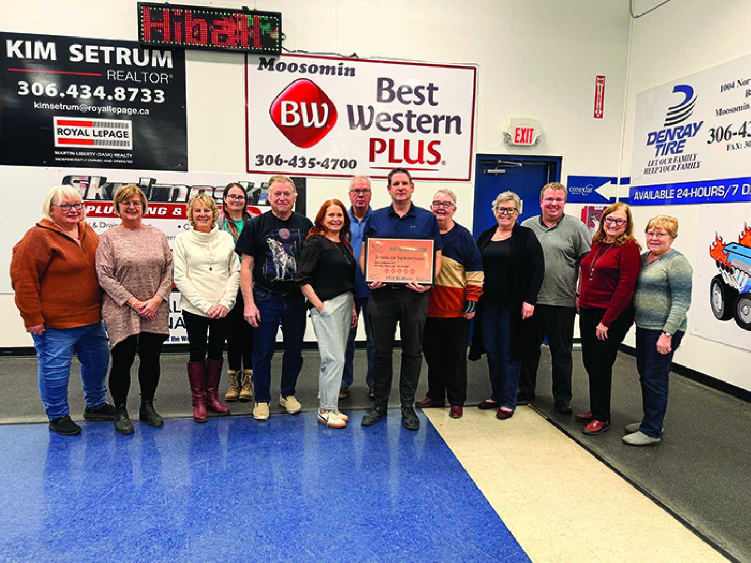 The Moosomin Communities in Bloom Committee with their national certificate for five blooms. From left are Kathy Doane, Pansy Taylor, Lyla Smart, Zoie Ferguson, Greg Nosterud, Angela Thorn, Mike Schwean, Mayor Murray Gray, Carol Fawcett, Karen Hebert, Andrew Exelby with Saskatchewan Parks and Rec who was there to present the certificate on Dec. 16, Ann Norgan, and Alice Abrahamson.